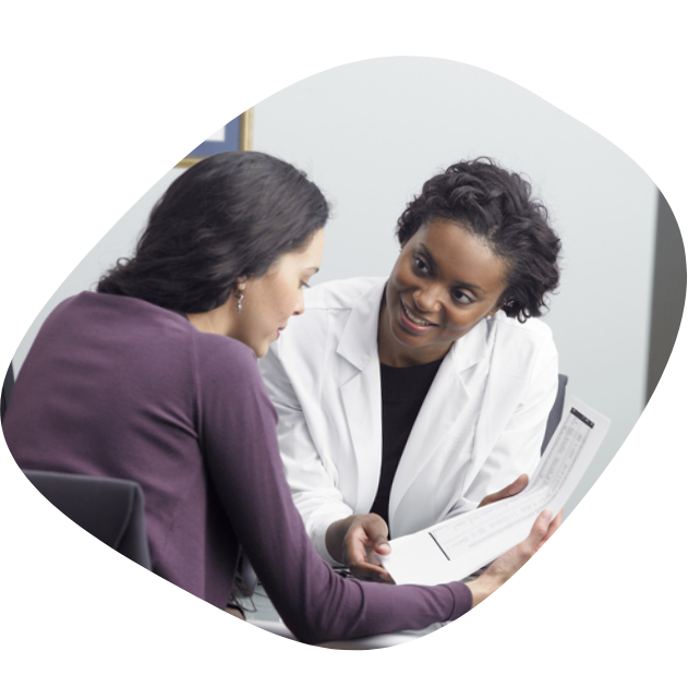 A female patient and her female doctor looking at a document together