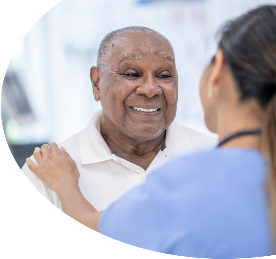 A male patient smiling at his healthcare professional