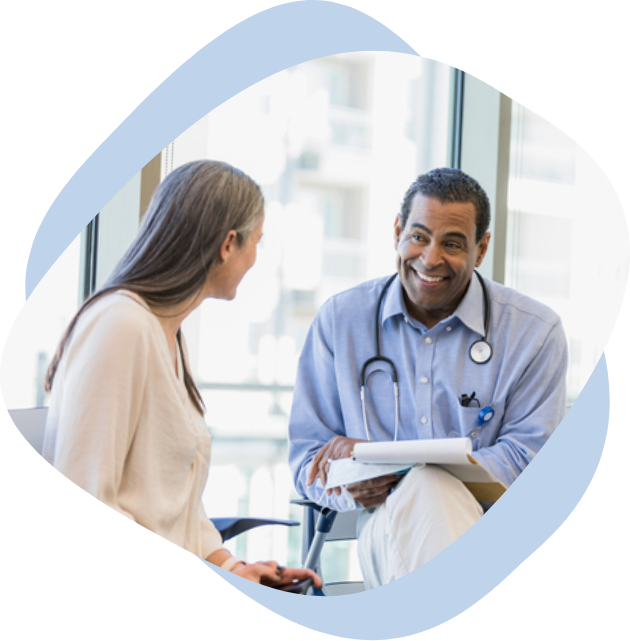 A male doctor smiling at his female patient