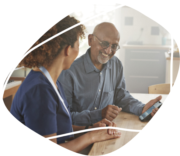 A female nurse smiling to her male patient