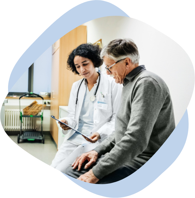 A female doctor showing results on a paper sheet to her middle-aged male patient