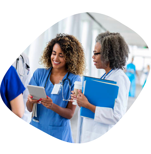 A female nurse looking at results on a cellphone with a female doctor