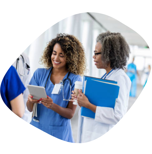 A female nurse looking at results on a cellphone with a female doctor