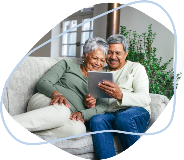 A husband showing his health results on a tablet to his wife