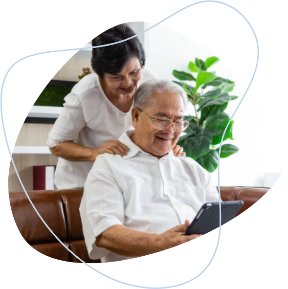 A husband showing his health results on a tablet to his wife