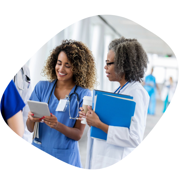 A female nurse looking at results on a cellphone with a female doctor