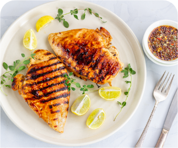 A plate of chicken and lemons